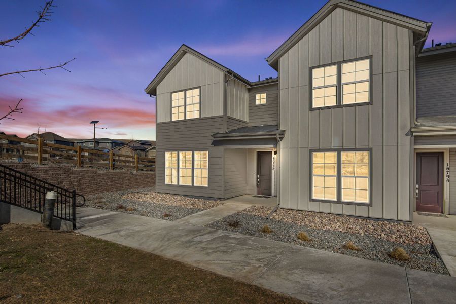 Front exterior of a new home in Candelas Townhomes, Arvada, CO, highlighting curb appeal (Image 20).