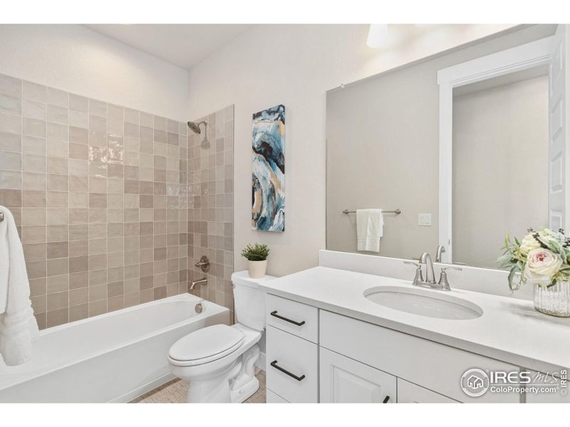 Full Bath main floor with White Sand Quartz Countertops!