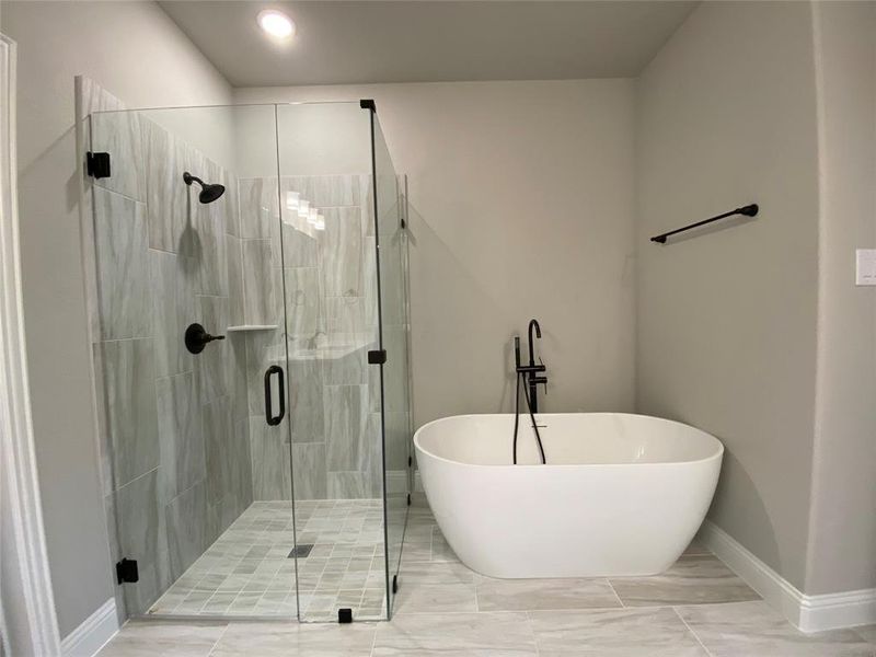 Master bath offers elegant free-standing tub and separate shower with bropped pan & frameless glass surround Master bath offers elegant free-standing tub and separate shower with bropped pan & frameless glass surround