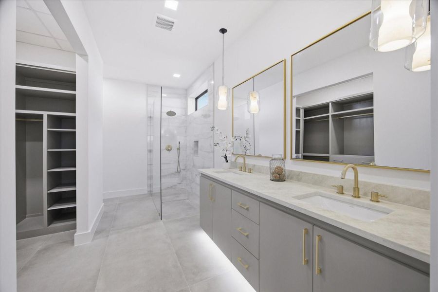 A spa-inspired bathroom unfolds with clean lines, soft tones, and a layout designed for both function and serenity.