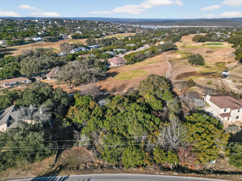 Aerial view of property and surrounding area featuring nearby suburban area
