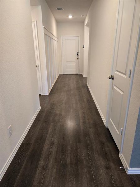 Hallway with dark wood-type flooring