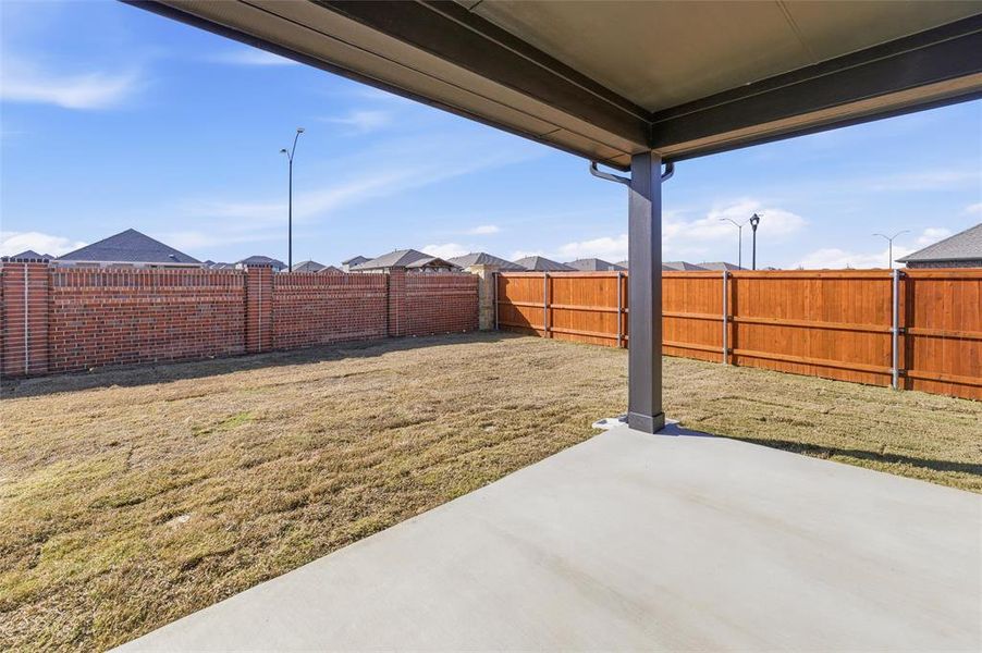 Fenced backyard featuring a patio area