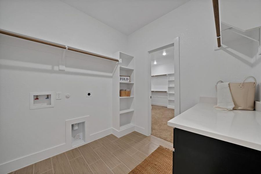 Laundry area featuring electric dryer hookup, hookup for a gas dryer, hookup for a washing machine.