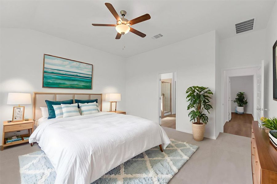 Bedroom featuring light carpet, ceiling fan, ensuite bath, and vaulted ceiling Bedroom featuring light carpet, ceiling fan, ensuite bath, and vaulted ceiling
