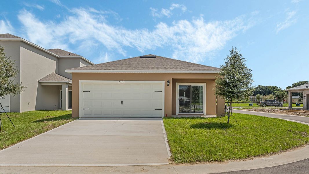 Front exterior of a new home in Crossroads at Kelly Park, Apopka, FL, highlighting curb appeal (Image 2). Front exterior of a new home in Crossroads at Kelly Park, Apopka, FL, highlighting curb appeal (Image 2).