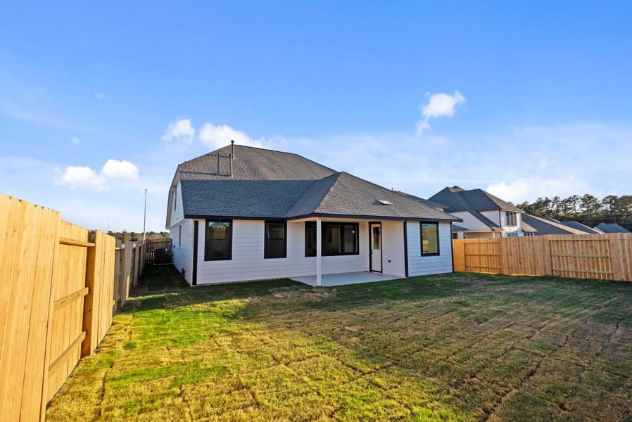 Exterior details and patio area of a home in Spring Creek Trails, Magnolia (Image 25).