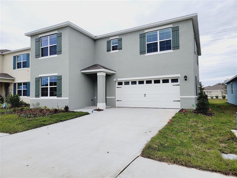 Front exterior of a new home in , Lake Alfred, FL, highlighting curb appeal (Image 1).