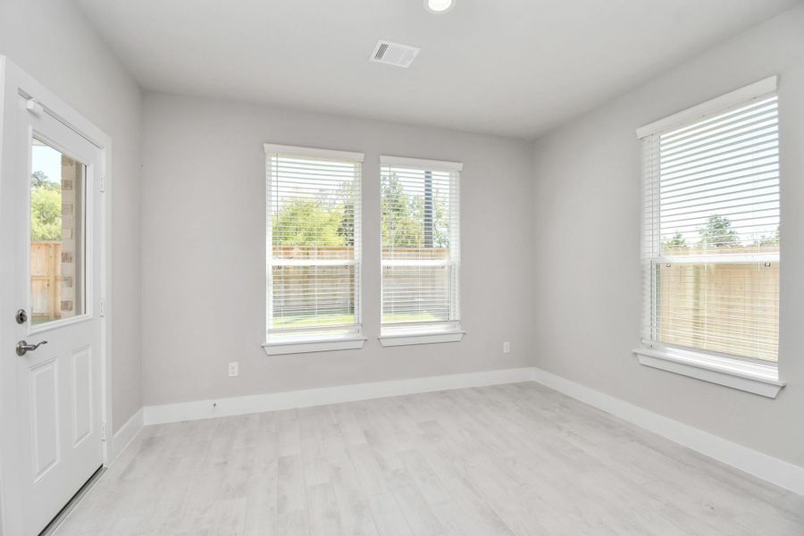 Enjoy breakfast with ease in the connected and cozy breakfast area, seamlessly integrated with the kitchen for utmost convenience. Step through the back door for a breath of fresh air onto the covered patio, extending your living space to the outdoors. Sample photo of completed home with similar floor plan. Actual colors and selections may vary.