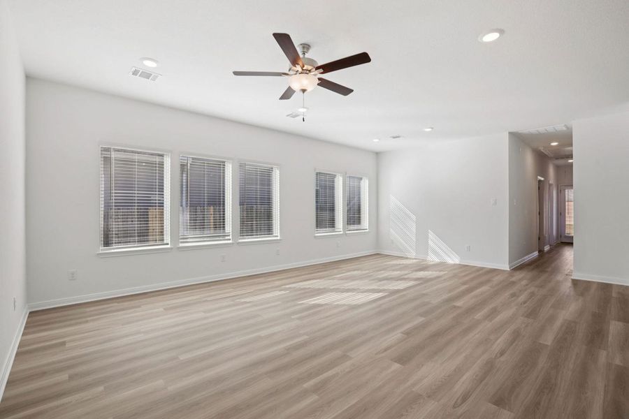 Empty room featuring a ceiling fan, light wood-style floors, and recessed lighting