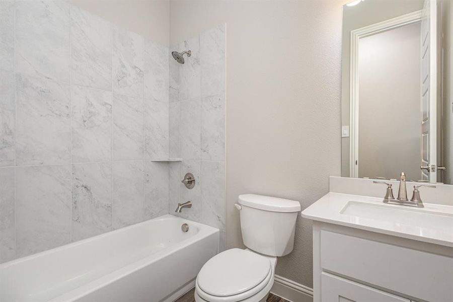 Full bathroom featuring bathing tub / shower combination and vanity Full bathroom featuring bathing tub / shower combination and vanity