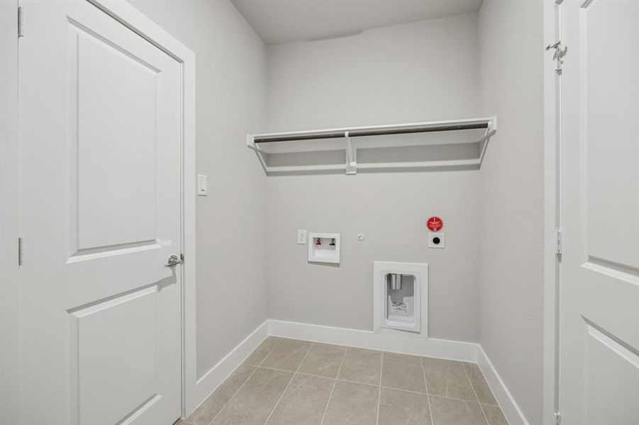 Laundry area featuring gas dryer hookup, washer hookup, light tile patterned flooring, and hookup for an electric dryer Laundry area featuring gas dryer hookup, washer hookup, light tile patterned flooring, and hookup for an electric dryer