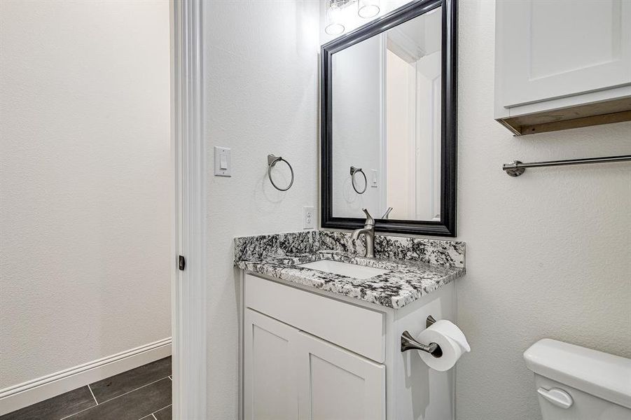 Bathroom featuring vanity and toilet