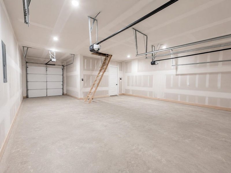 Spacious 3 car tandem garage opening to the rear side of the home.