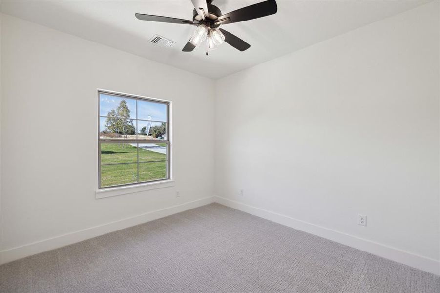 Unfurnished room with ceiling fan and carpet floors