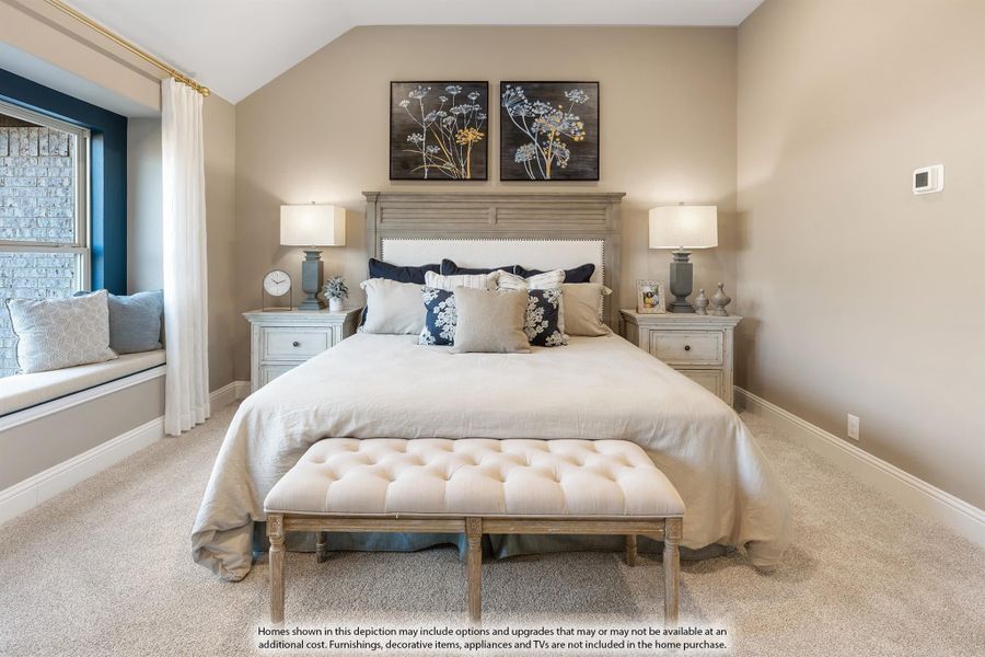Bedroom with vaulted ceiling, king bed, window seat, and neutral carpet flooring Bedroom with vaulted ceiling, king bed, window seat, and neutral carpet flooring