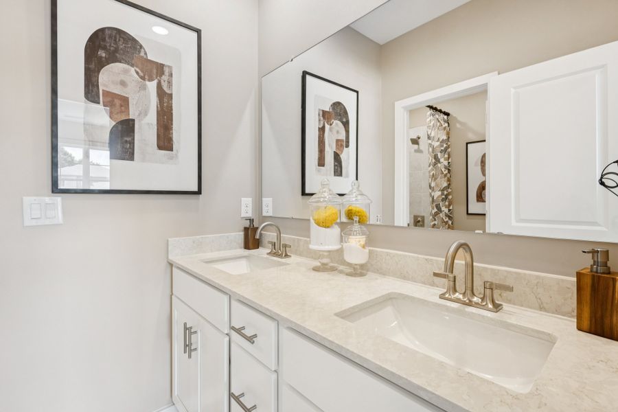 A bathroom with a couple of sinks. A bathroom with a couple of sinks.