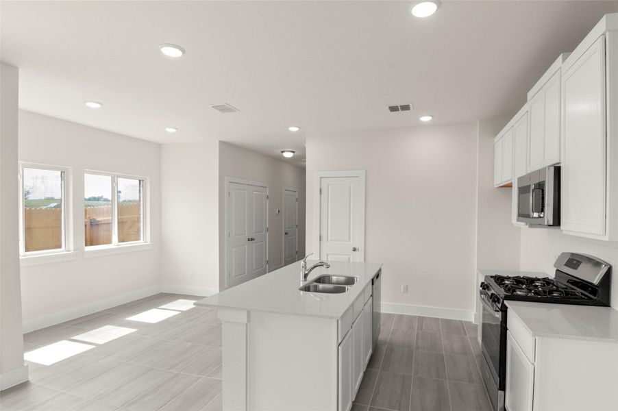 Kitchen featuring visible vents, baseboards, recessed lighting, a sink, and appliances with stainless steel finishes