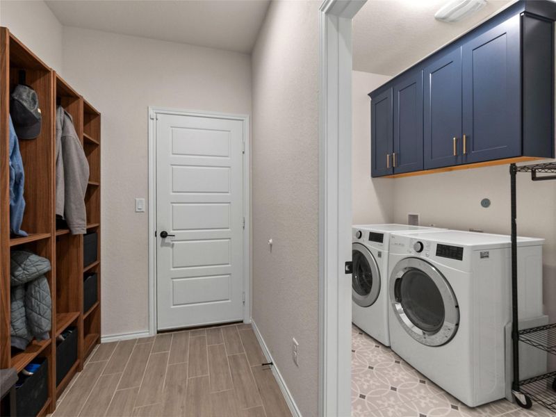 Laundry room with cabinet space, and wood tiled floors