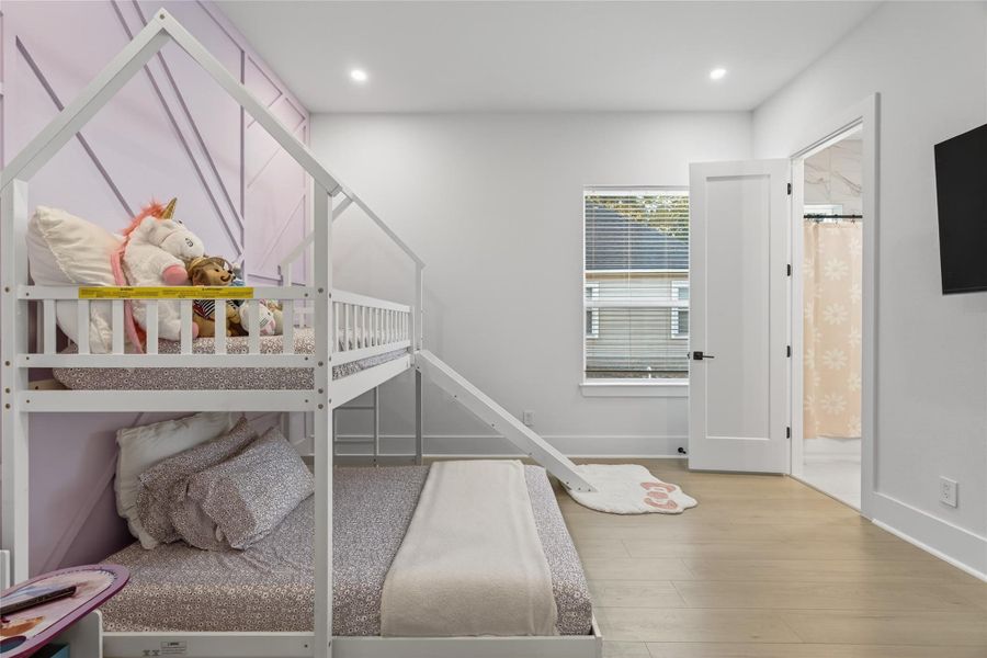 Secondary bedroom offers a bright and versatile space with a large window and neutral finishes. **Images are from a previously completed project. **
