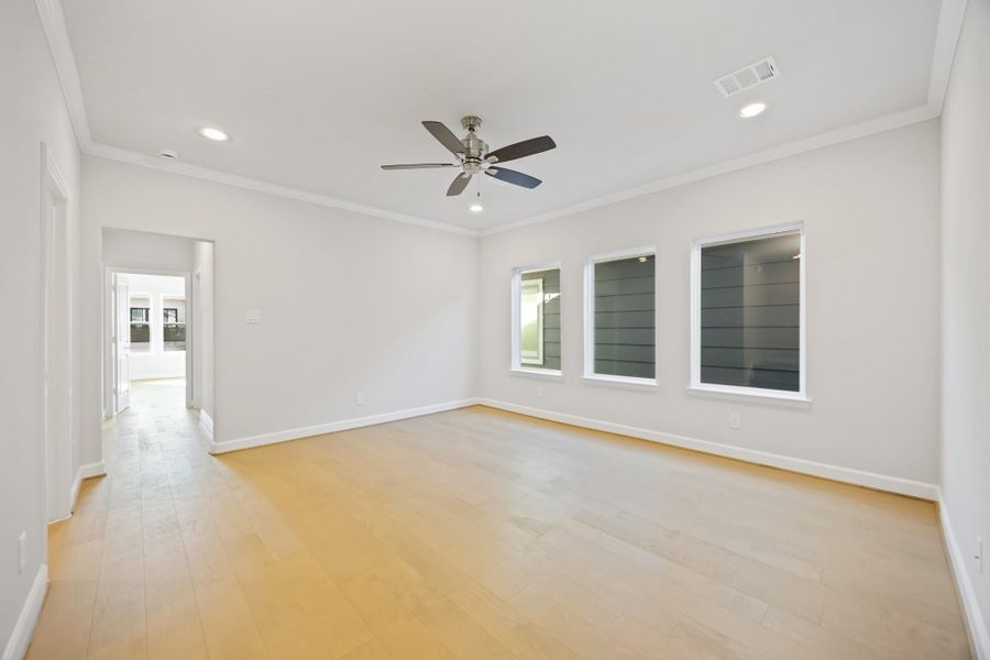 The second-story game room, a realm of leisure nestled between the serenity of the primary suite and the charm of a secondary bedroom, brightened by an expansive wall of windows. The second-story game room, a realm of leisure nestled between the serenity of the primary suite and the charm of a secondary bedroom, brightened by an expansive wall of windows.