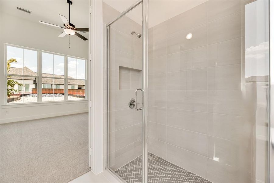 Full bathroom featuring carpet flooring, a stall shower, and ceiling fan Full bathroom featuring carpet flooring, a stall shower, and ceiling fan