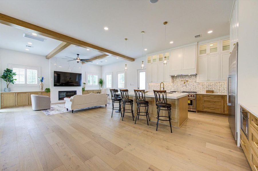 Custom inset cabinetry throughout, with White Oak finishes in the kitchen, living area, and primary bathroom.