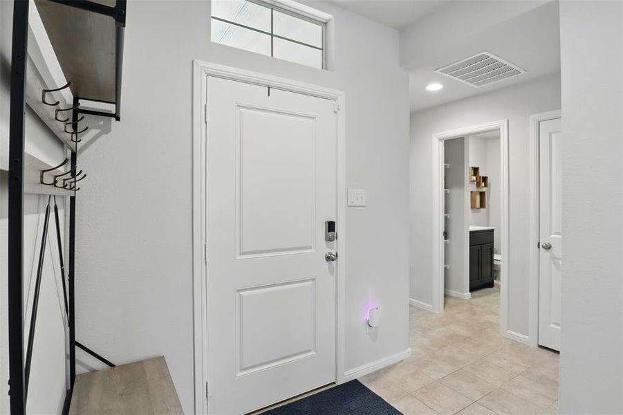Entryway, recessed lighting, and light tile patterned floors