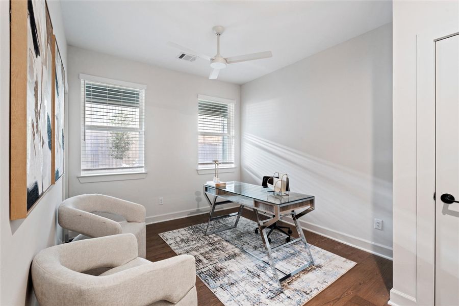 This spacious room shows it's versatility as an office or ideal for guests with natural light found throughout.