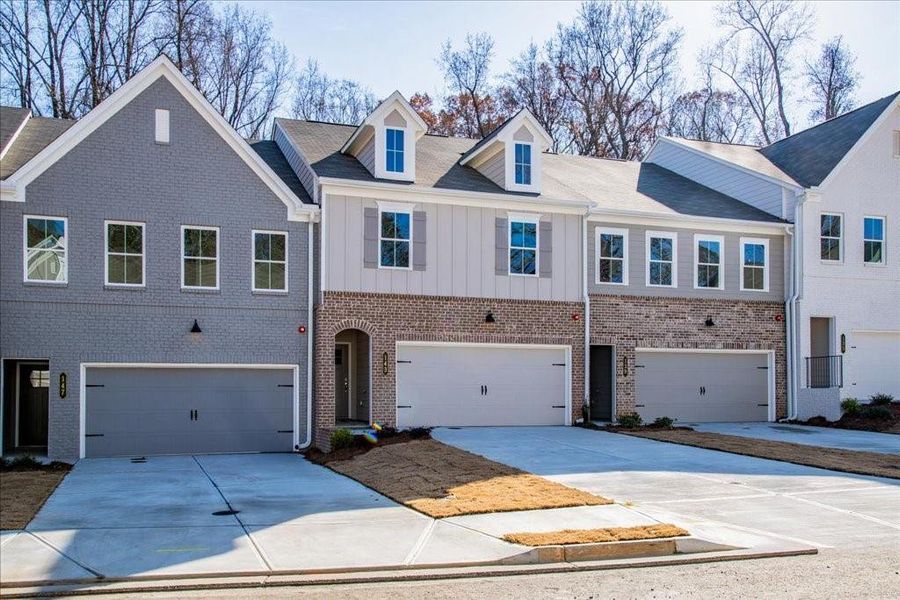 Front exterior of a new home in Bluffs at Bells Ferry, Marietta, GA, highlighting curb appeal (Image 1). Front exterior of a new home in Bluffs at Bells Ferry, Marietta, GA, highlighting curb appeal (Image 1).