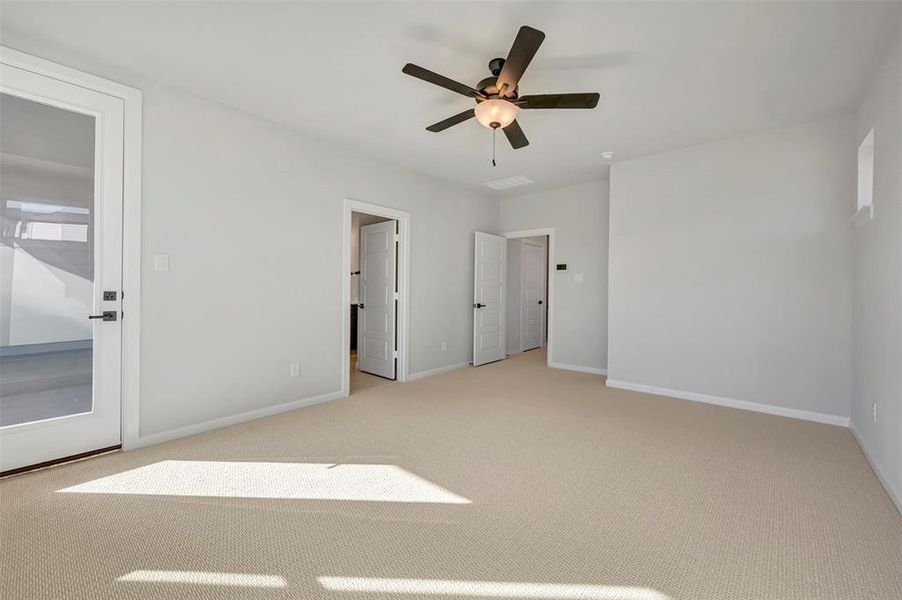 Unfurnished bedroom with light carpet and ceiling fan Unfurnished bedroom with light carpet and ceiling fan