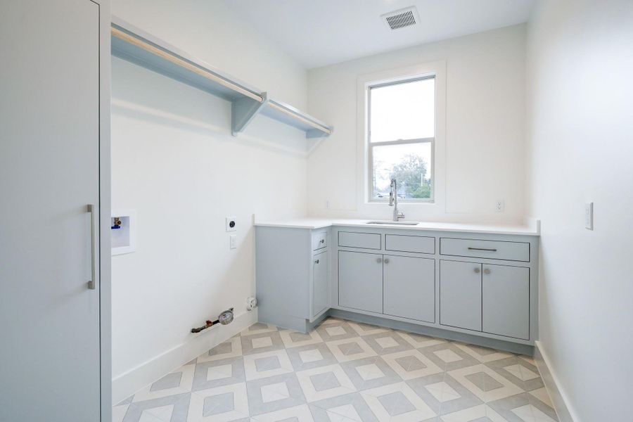 Utility room located on the second floor with sink and plenty of storage and counter space. *Previous Proiect*