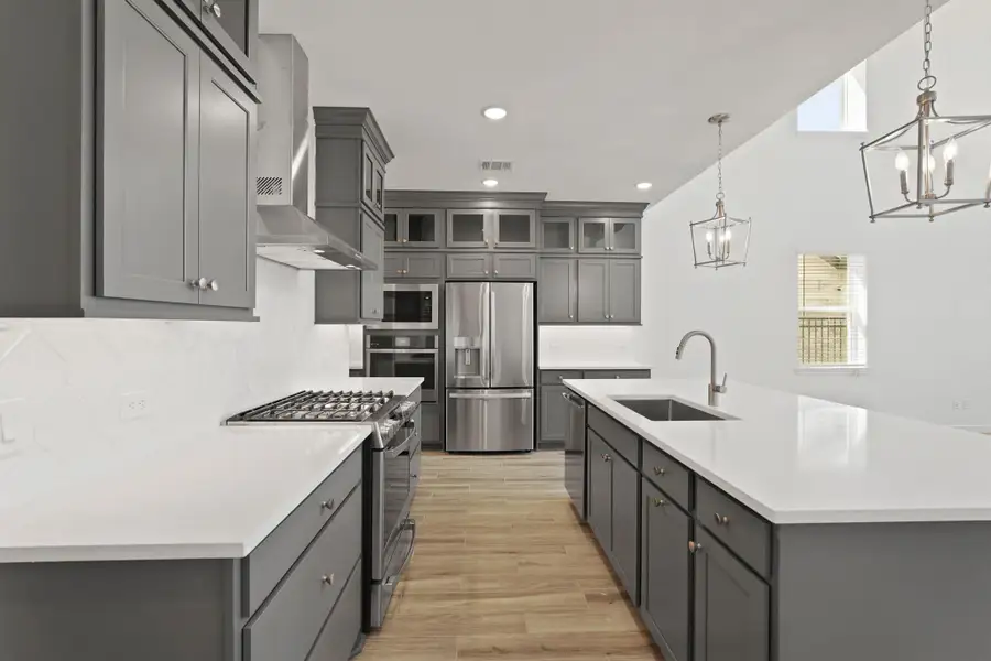 Stylish kitchen with grey stacked cabinets and quartz counters (*Photo not of actual home and used for illustration purposes only.) Stylish kitchen with grey stacked cabinets and quartz counters (*Photo not of actual home and used for illustration purposes only.)