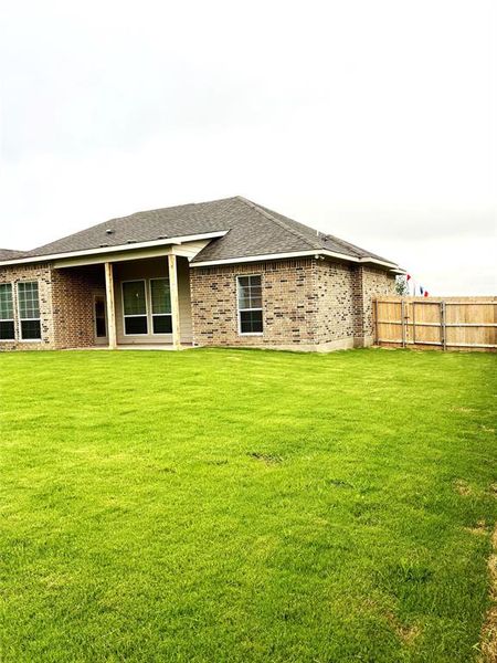 Rear view of house featuring brick siding and roof with shingles Rear view of house featuring brick siding and roof with shingles