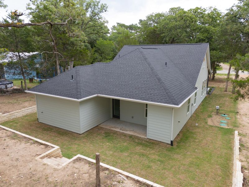 Great view of the back of the house covered patio, and still with a great oversize backyard oasis.