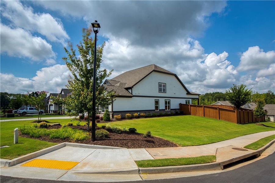 Front exterior of a new home in Yellowstone Farms, Cumming, GA, highlighting curb appeal (Image 1). Front exterior of a new home in Yellowstone Farms, Cumming, GA, highlighting curb appeal (Image 1).