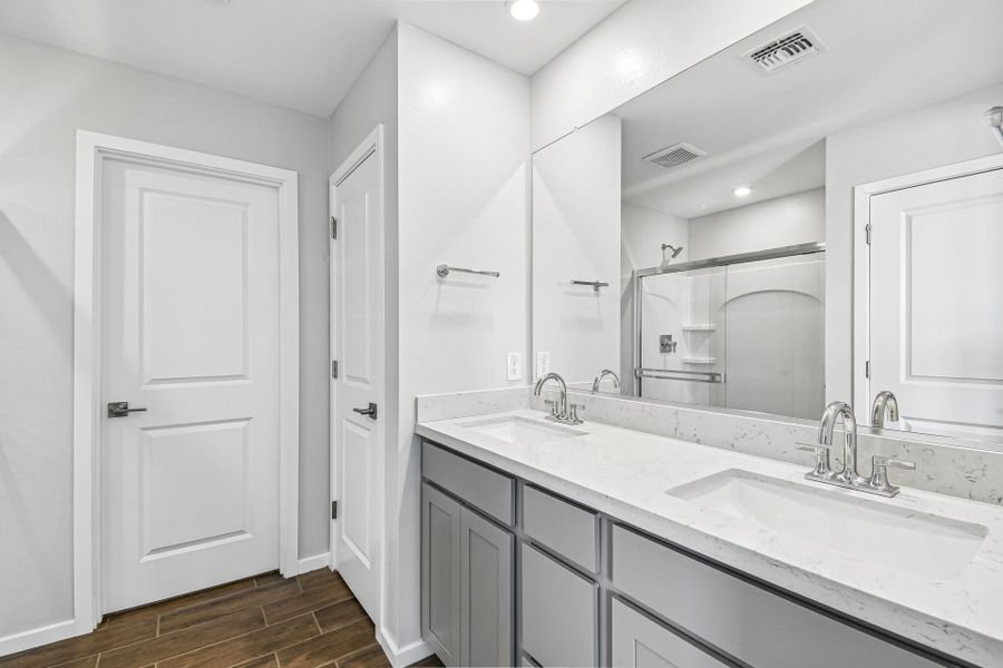A bathroom with white cabinets. A bathroom with white cabinets.