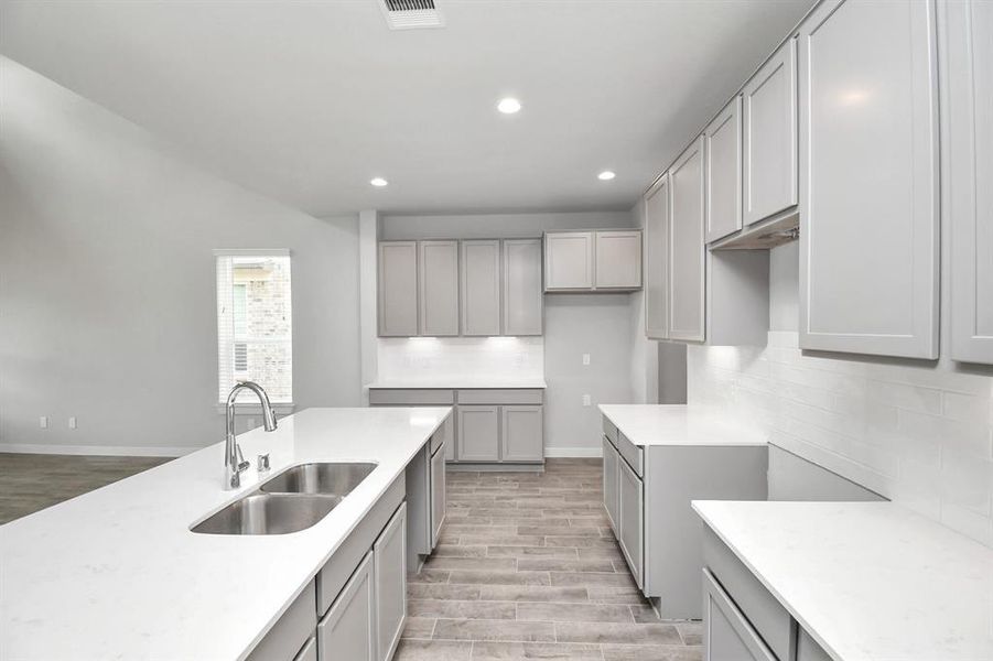 Another view of the kitchen show casing the abundance of counter top space.