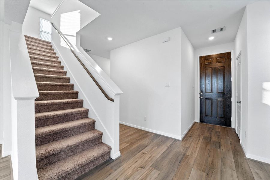 Walking into this gorgeous home, you get a feel of just how warm and open everything is, this entryway features high ceilings, recessed lighting, gorgeous vinyl plank flooring, custom paint, and a covenient coat closet. Walking into this gorgeous home, you get a feel of just how warm and open everything is, this entryway features high ceilings, recessed lighting, gorgeous vinyl plank flooring, custom paint, and a covenient coat closet.
