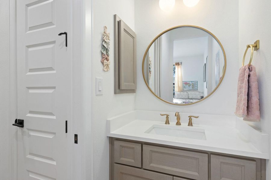 Bathroom featuring vanity and connected bathroom