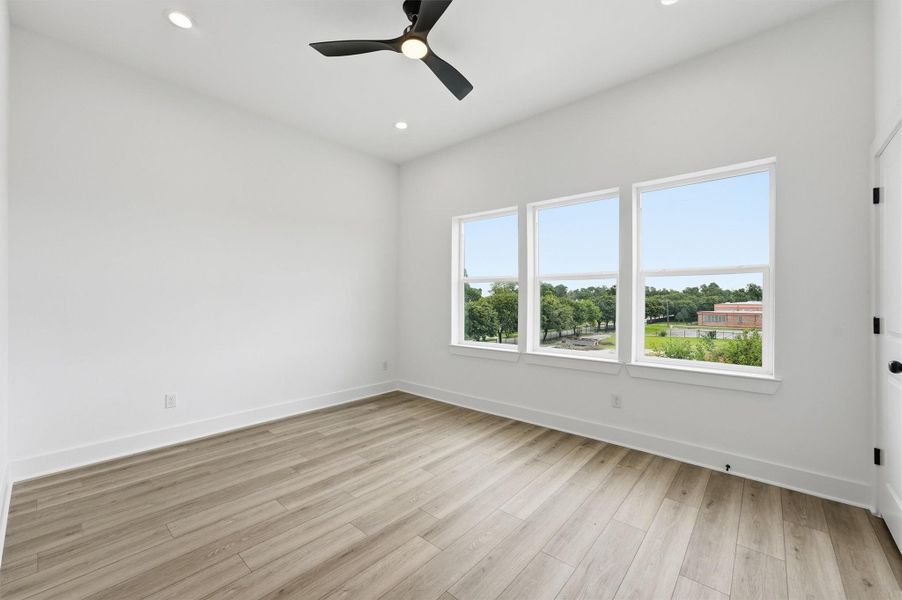 This is your sanctuary. A spacious primary suite with a wall of triple windows overlooking open green space, recessed lighting, and generous room proportions gives you the peaceful escape you deserve at the end of every day. This is your sanctuary. A spacious primary suite with a wall of triple windows overlooking open green space, recessed lighting, and generous room proportions gives you the peaceful escape you deserve at the end of every day.
