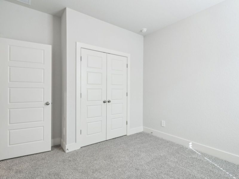 Guest bedroom in the San Saba floorplan at a Meritage Homes community.