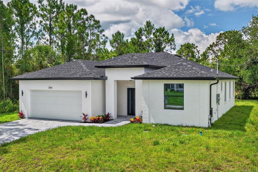 Front exterior of a new home in , North Port, FL, highlighting curb appeal (Image 24). Front exterior of a new home in , North Port, FL, highlighting curb appeal (Image 24).
