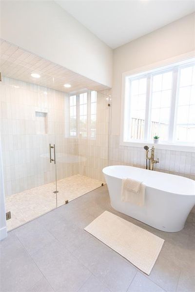 Contemporary bathroom featuring a spacious walk-in shower with glass enclosure and a freestanding soaking tub