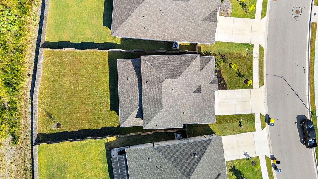 Bird’s-eye view showcasing the spacious lot and fenced backyard. Bird’s-eye view showcasing the spacious lot and fenced backyard.