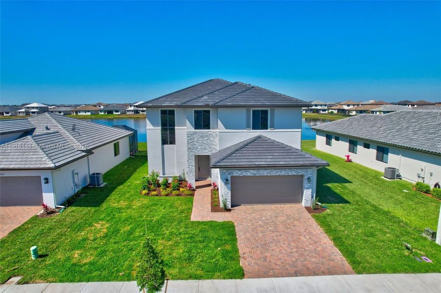 Front exterior of a new home in , Ave Maria, FL, highlighting curb appeal (Image 1).