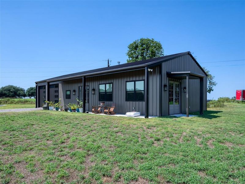 View of front of property featuring board and batten siding and a front yard View of front of property featuring board and batten siding and a front yard