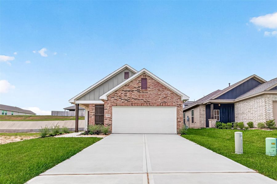 Front exterior of a new home in Mostyn Springs, Magnolia, TX, highlighting curb appeal (Image 1). Front exterior of a new home in Mostyn Springs, Magnolia, TX, highlighting curb appeal (Image 1).