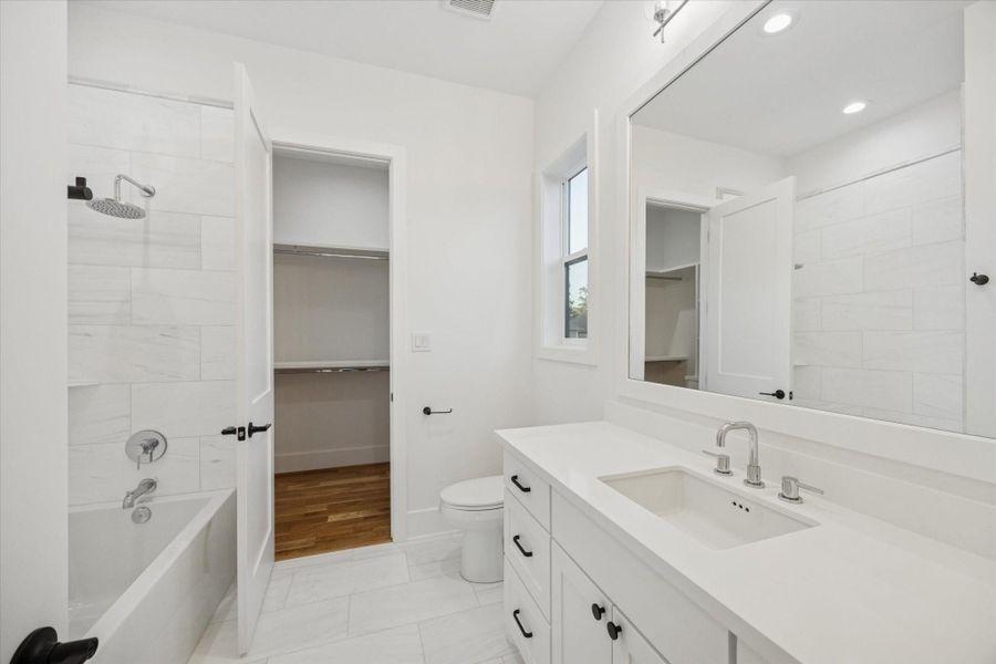 Designed for comfort and privacy, the en suite bath offers a tub and shower combination with clean tilework and modern fixtures. Direct access to a walk in closet and a spacious vanity makes daily routines efficient while keeping the bedroom feeling uncluttered and private. Designed for comfort and privacy, the en suite bath offers a tub and shower combination with clean tilework and modern fixtures. Direct access to a walk in closet and a spacious vanity makes daily routines efficient while keeping the bedroom feeling uncluttered and private.