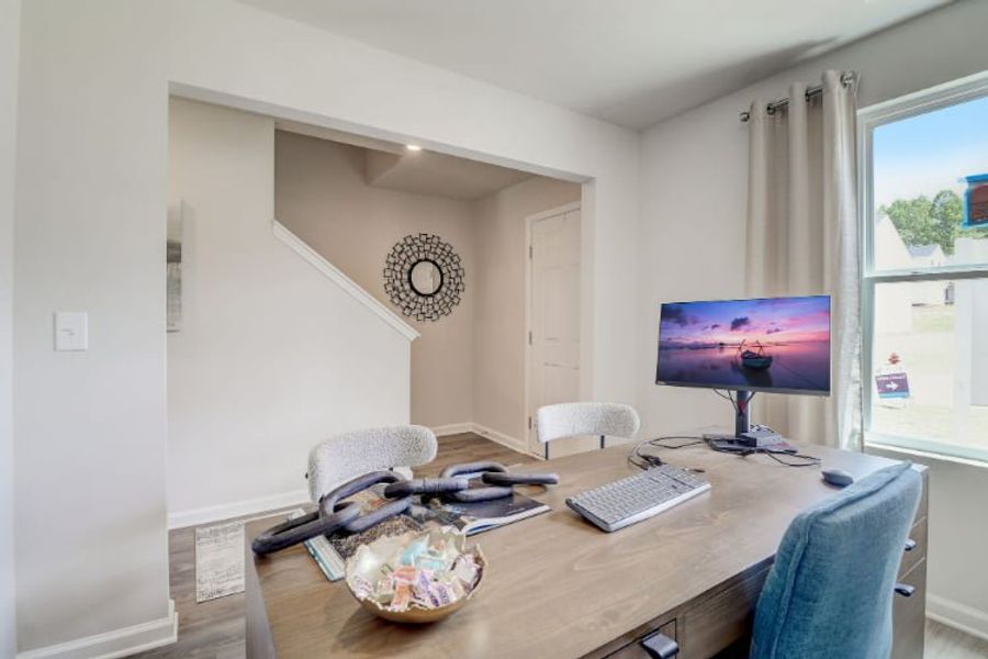 A room with a desk and a computer. A room with a desk and a computer.